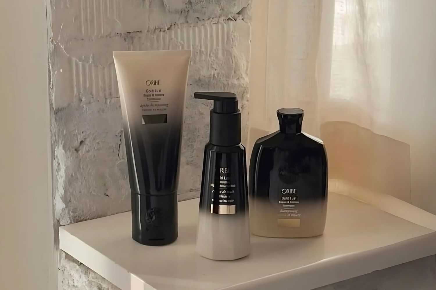 Luxurious hair care products on a shelf against a brick wall background.