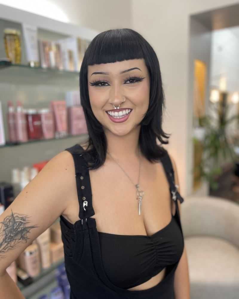 Portrait of MAYA, a professional stylist at 77Salon Inc., showcasing their expertise and style.