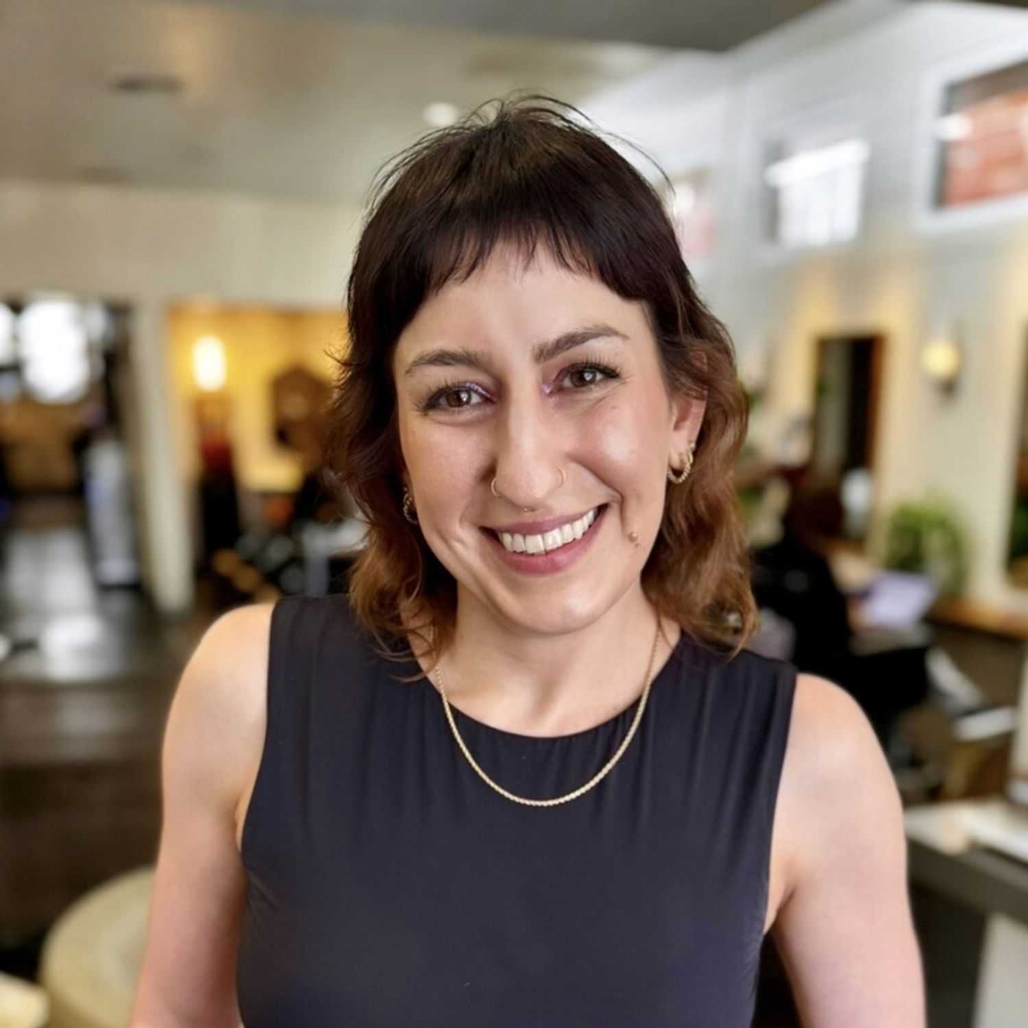 Portrait of LINDA KONSTANTIN, a professional stylist at 77Salon Inc., showcasing their expertise and style.