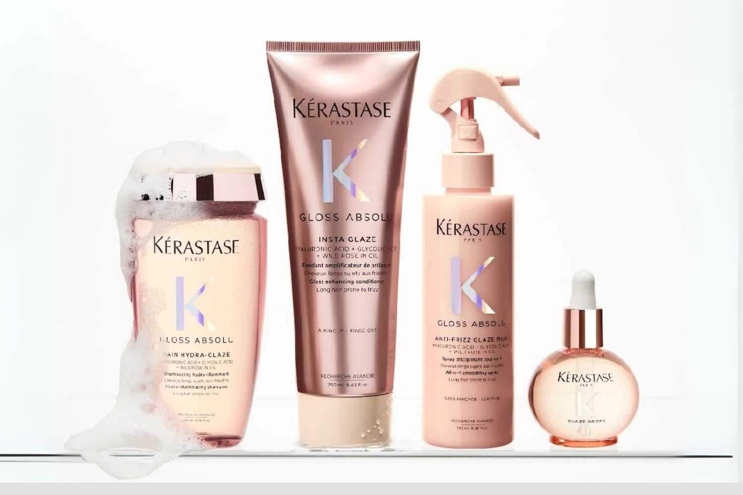Kerastase Gloss Absolu hair products lineup on a white surface, including sprays and serum.